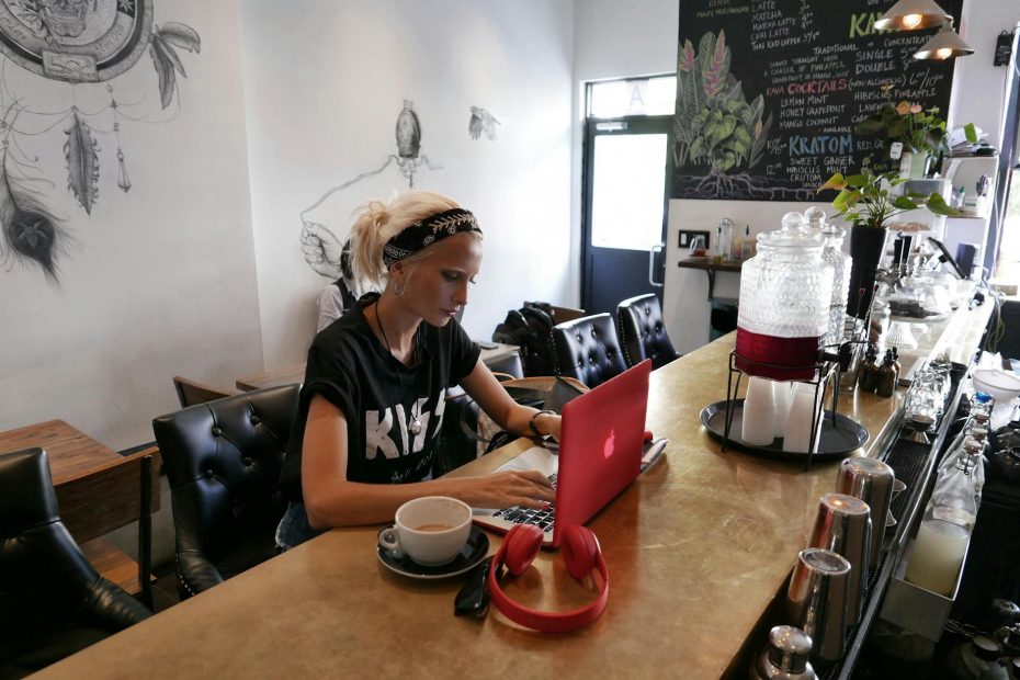 woman wears black kiss print crew neck shirts sits