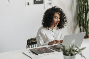 a woman with curly hair using laptop